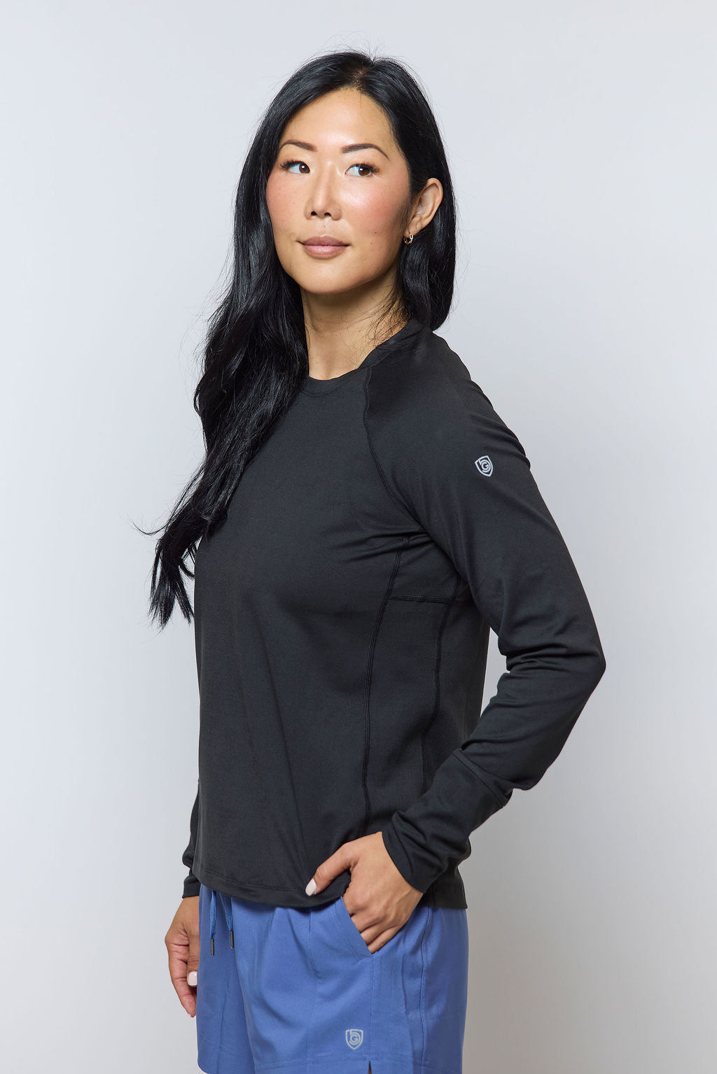 Black Foudy 2.0 long-sleeve top, three-quarter view showing the shoulder logo