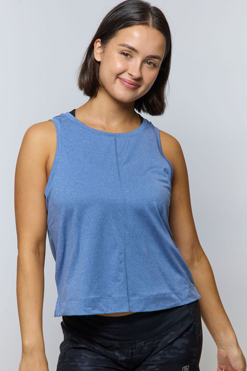 Front view of a model wearing a blue Goal Five Boxy Crop Tank