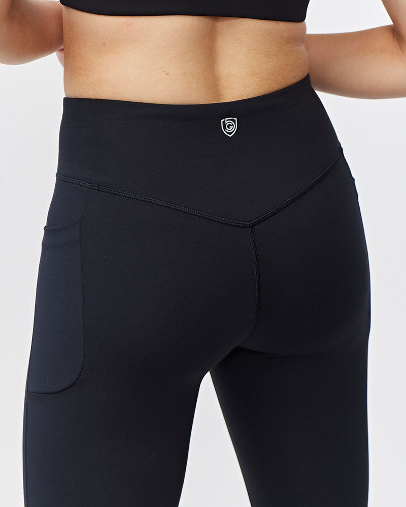 Black Go Again cropped leggings, close-up of the back waistband, logo and seams