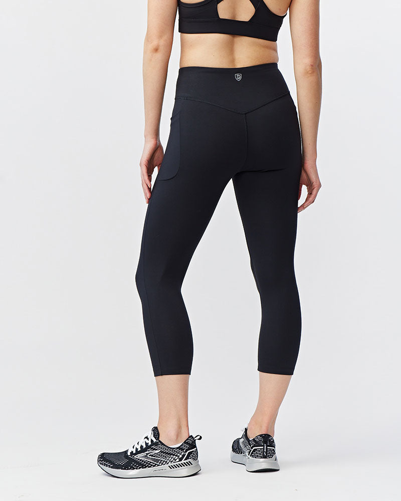 Black Go Again cropped leggings, back view showing the waistband and calf-length hems