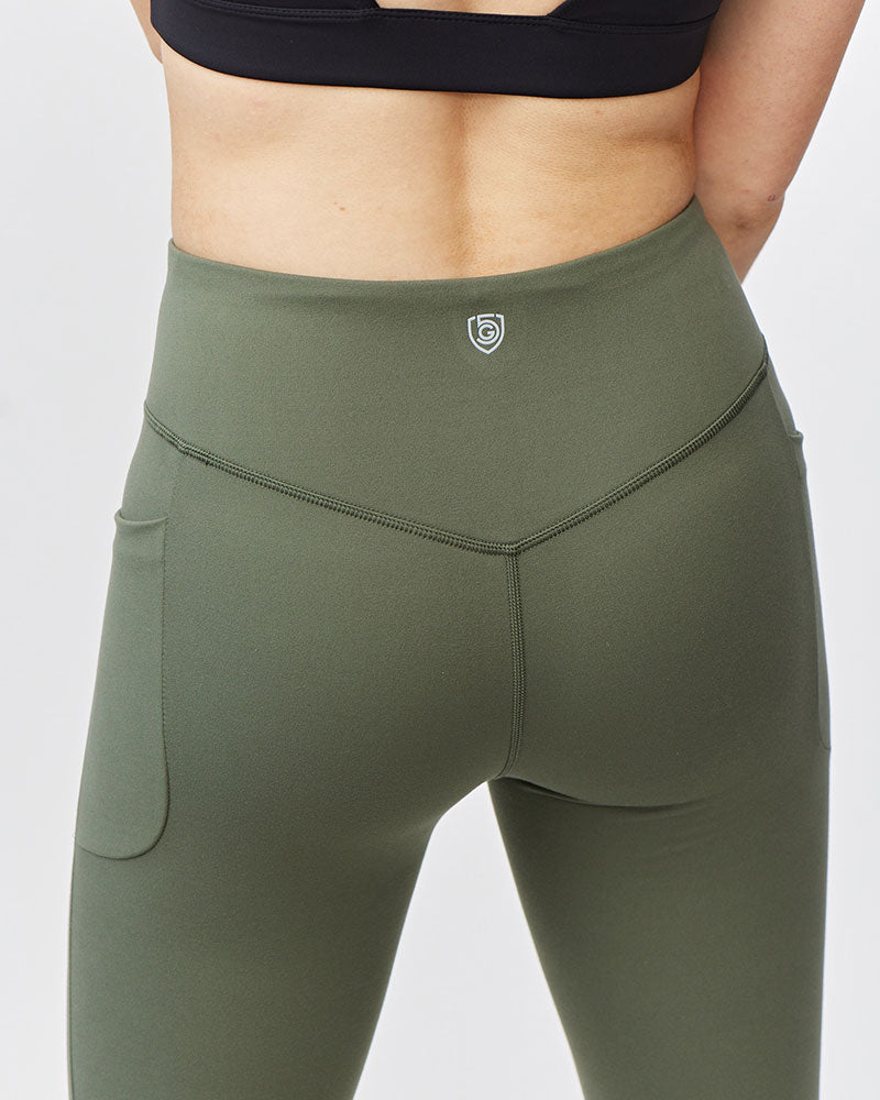 Olive green Go Again cropped leggings, close-up of the back waistband, logo and seams