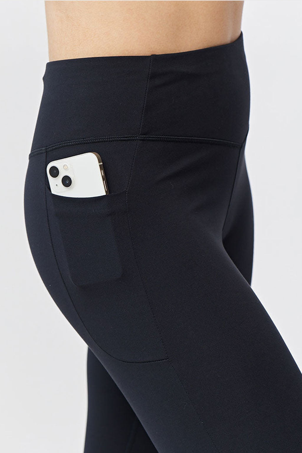 Black Go Again cropped leggings, close-up of the side pocket holding a phone
