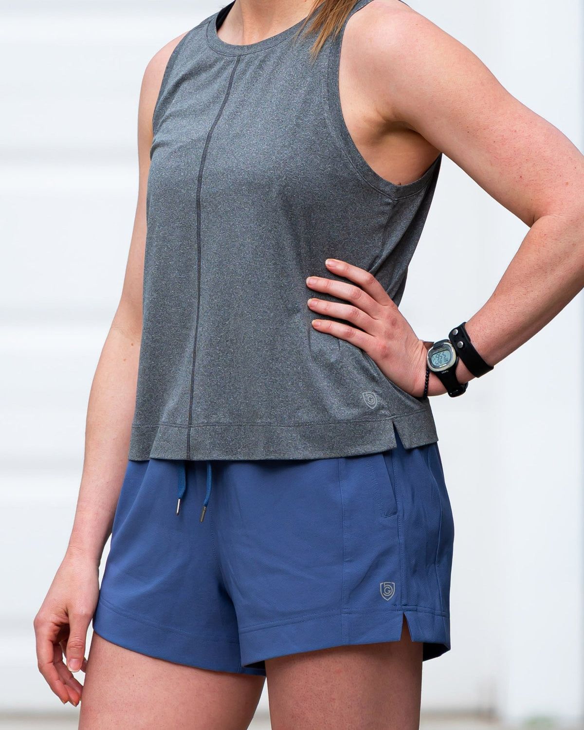 Gray Boxy Crop Tank, close-up showing the front seam and side slit at the hem