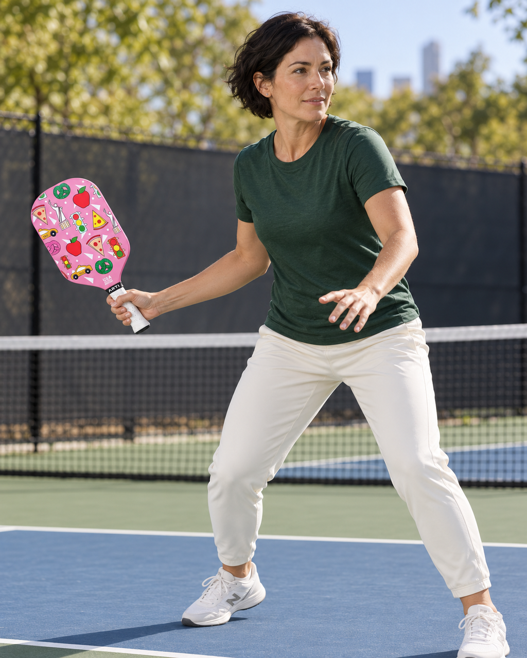 AI-assisted pickleball scene of one adult woman forehand preparation using the pink ARTI NEW YORK paddle. Original supplier photos show product details.